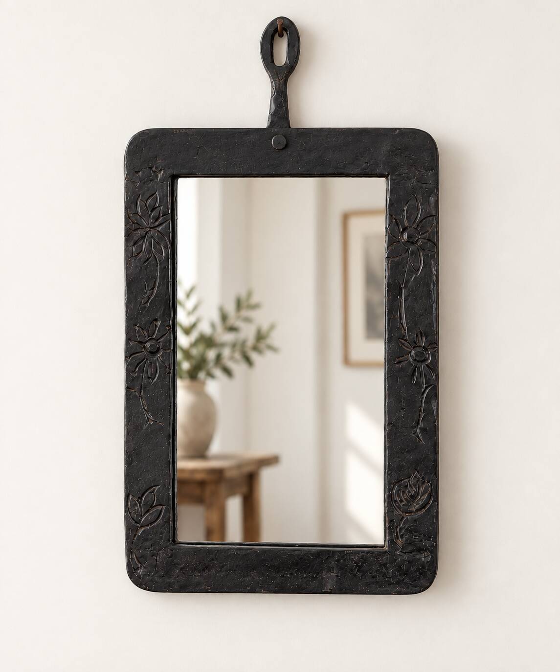 Vintage black wall mirror with floral decoration