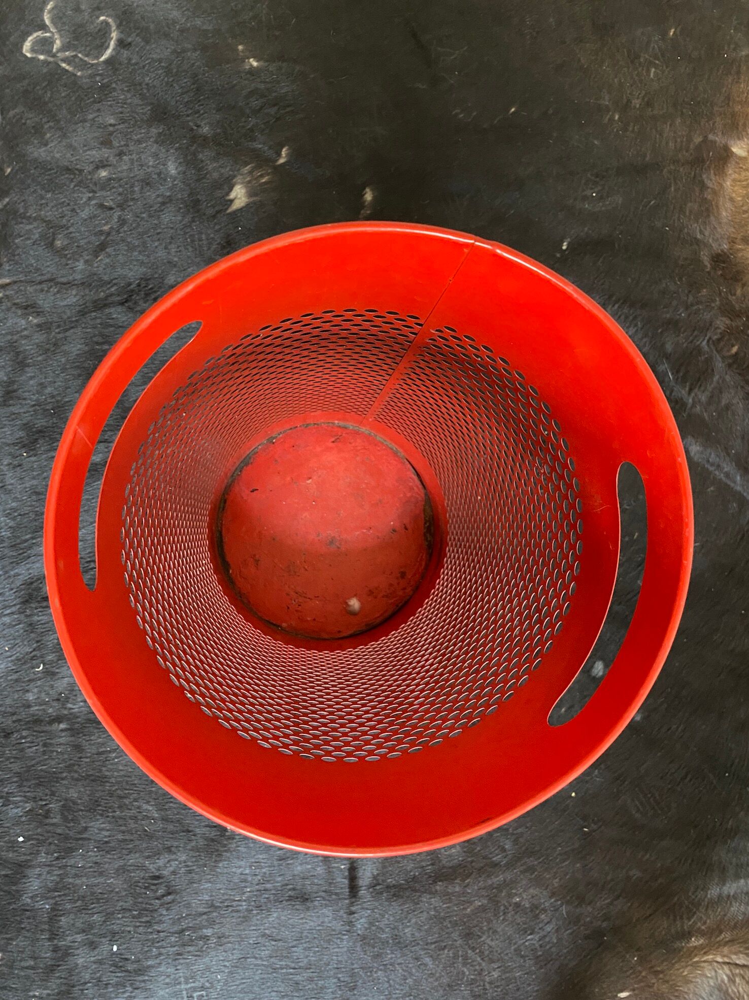 Vintage red umbrella holder in 80s perforated sheet metal or Italy trash can