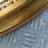 Antique oval mirror in gilded stucco with gold leaf, 19th century
