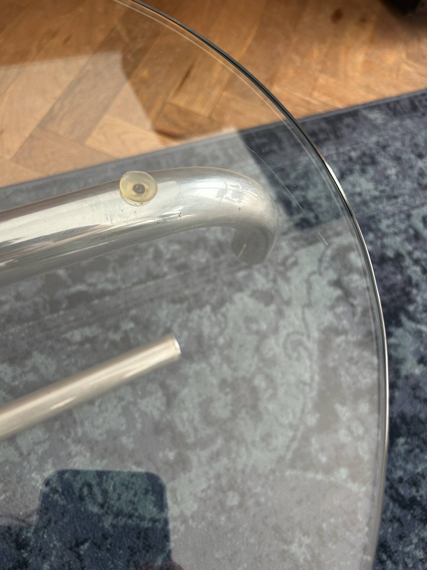 Oval glass coffee table with chrome legs, vintage 70s design.