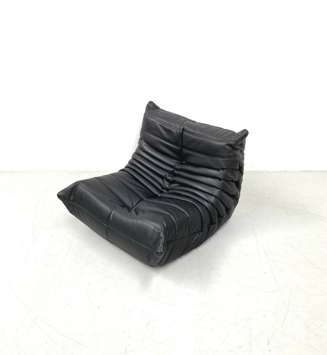 Set of French Togo lounge chair and ottoman in black leather attributed to Michel Ducaroy for Ligne Roset, 1970s
