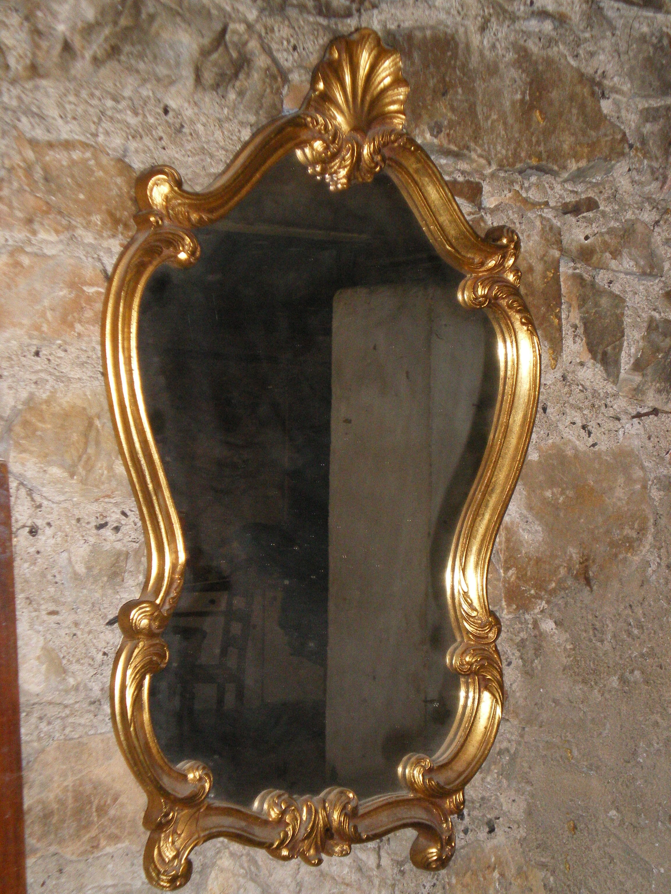 Large gilded mirror Louis XV style with shell.