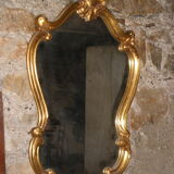 Large gilded mirror Louis XV style with shell.