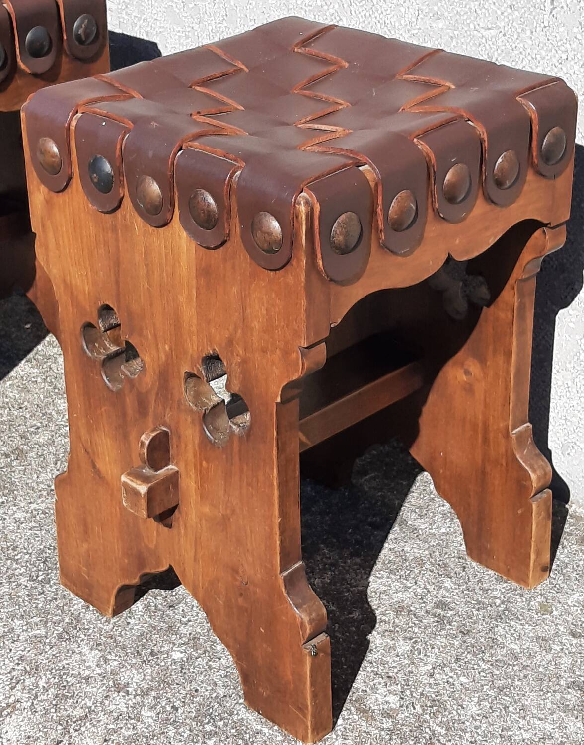Pair of brutalist stools, leather seat.