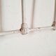 Cast-iron headboard and patinated white wood