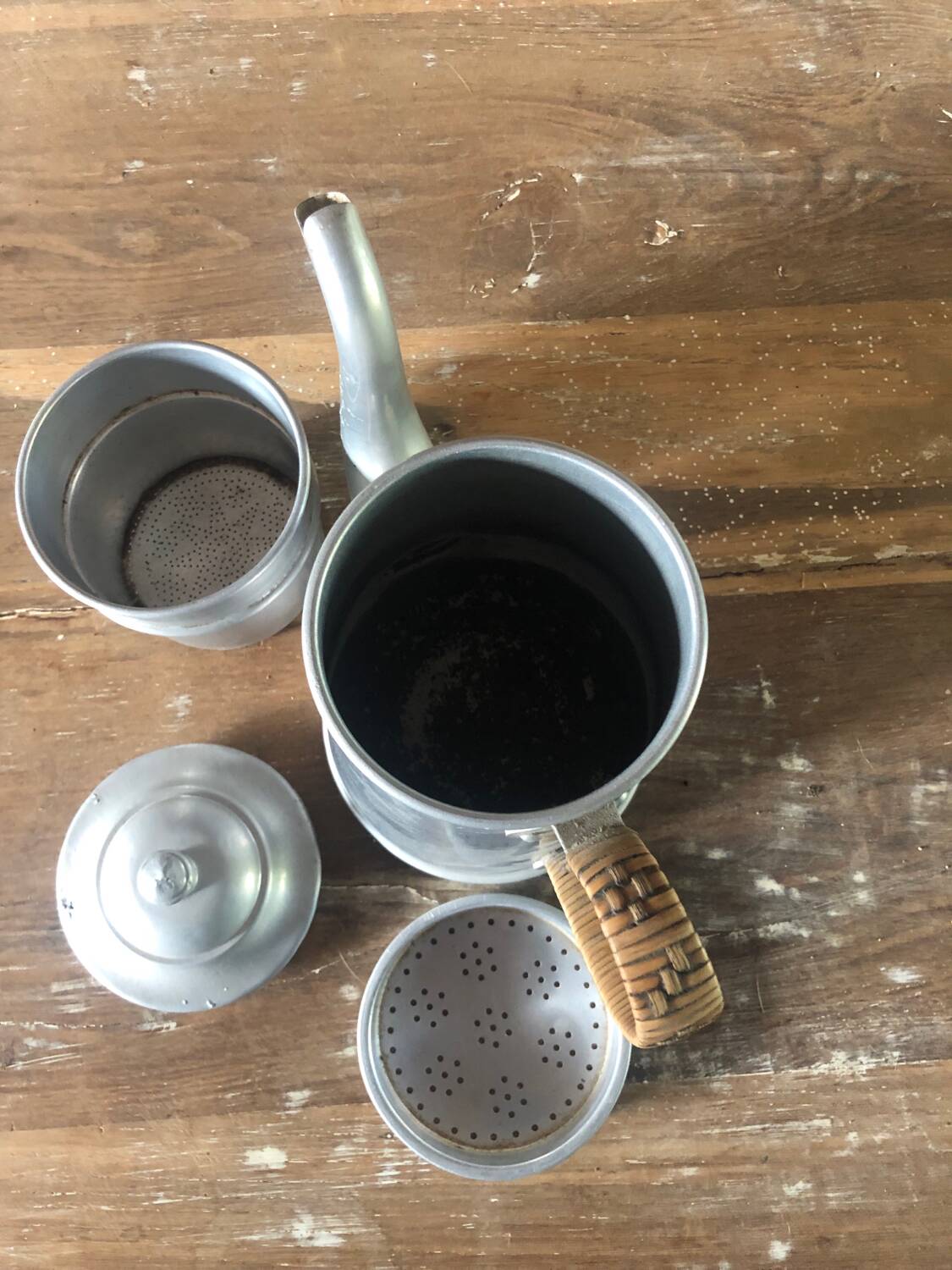 Old aluminum coffee maker, woven wicker handle