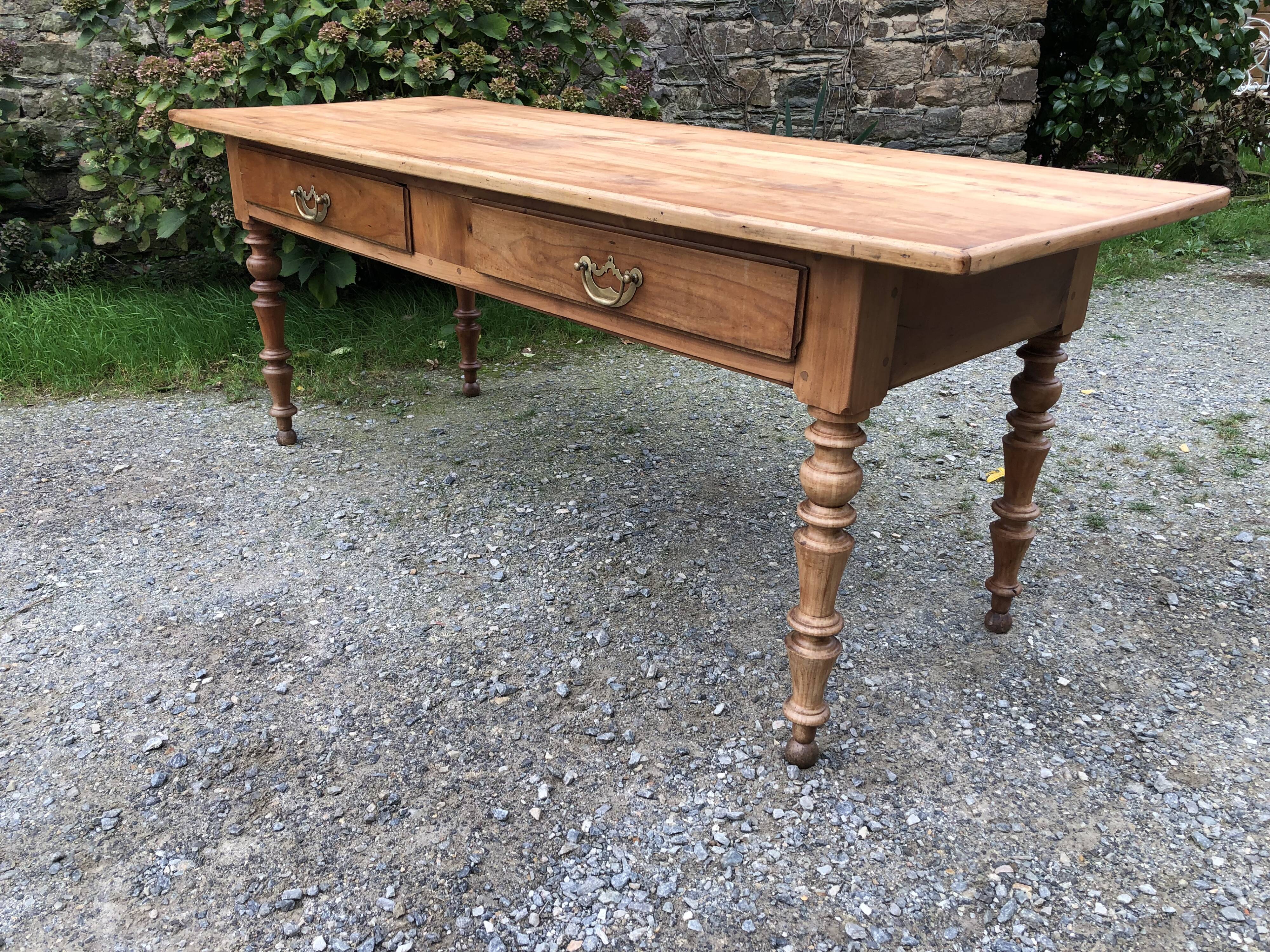 Antique Louis Philippe style farm table in solid cherry wood with 2 drawers and turned base.