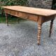 Antique Louis Philippe style farm table in solid cherry wood with 2 drawers and turned base.