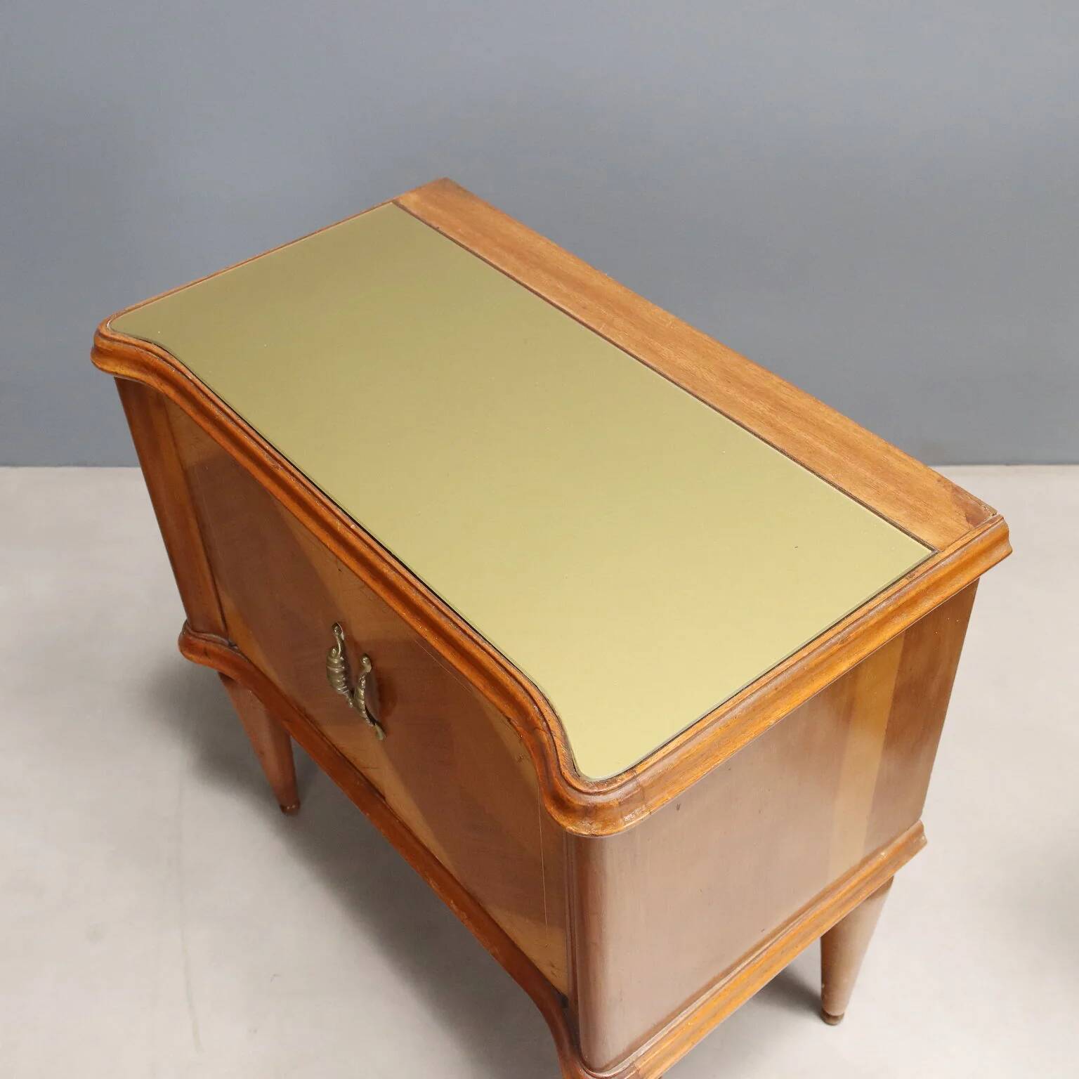 Pair of wooden and glass bedside tables from the 1950s.