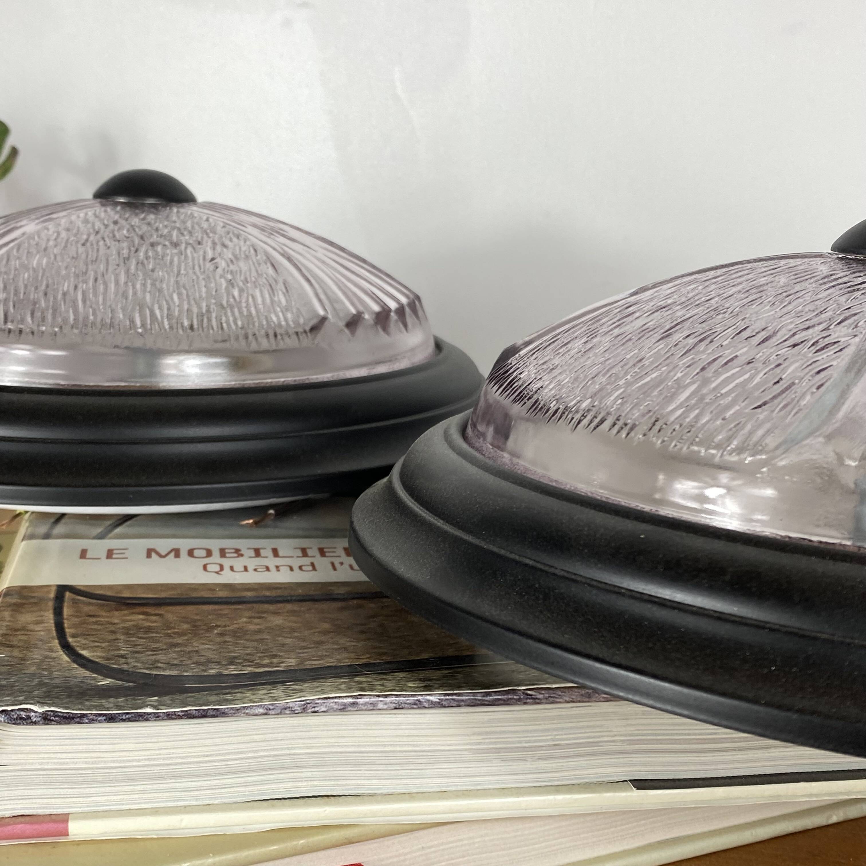 Pair of slightly pink glass ceiling lights and vintage black metal.