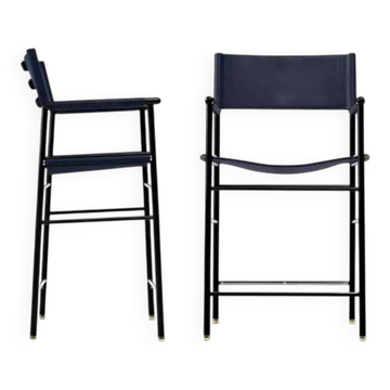 Pair of bar stools with navy blue backrest and metal frame.