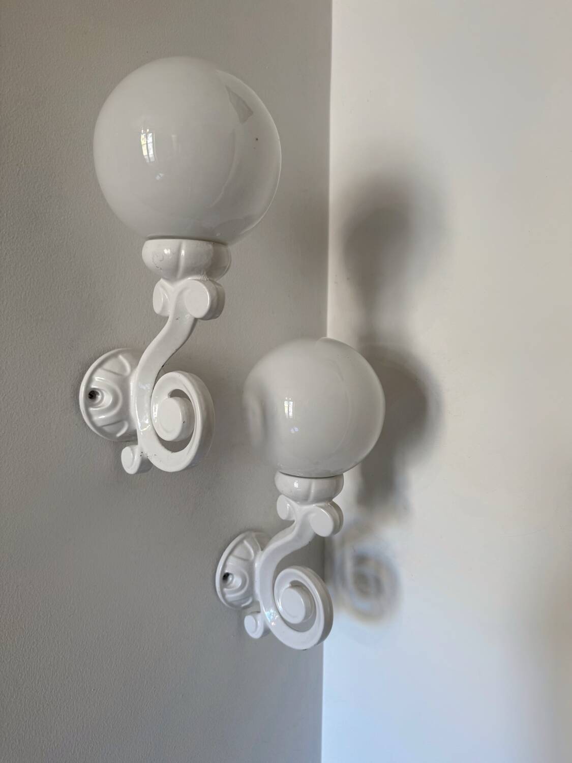 Cast iron and opaline wall lights from the 70s
