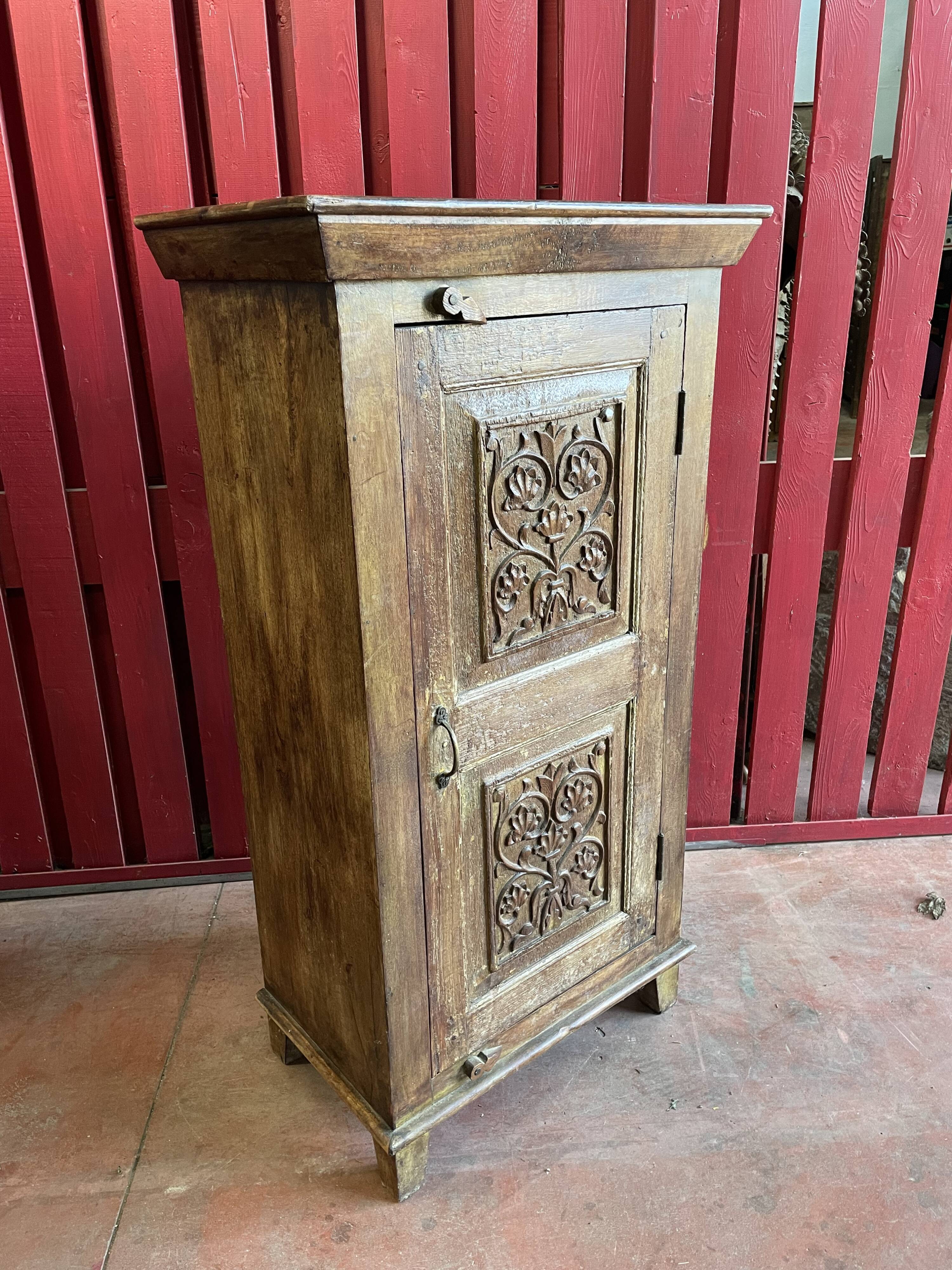 India. Bonnetière with a teak door finely carved by hand.