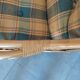 Vintage armchair in bamboo and rattan with a tartan pattern.