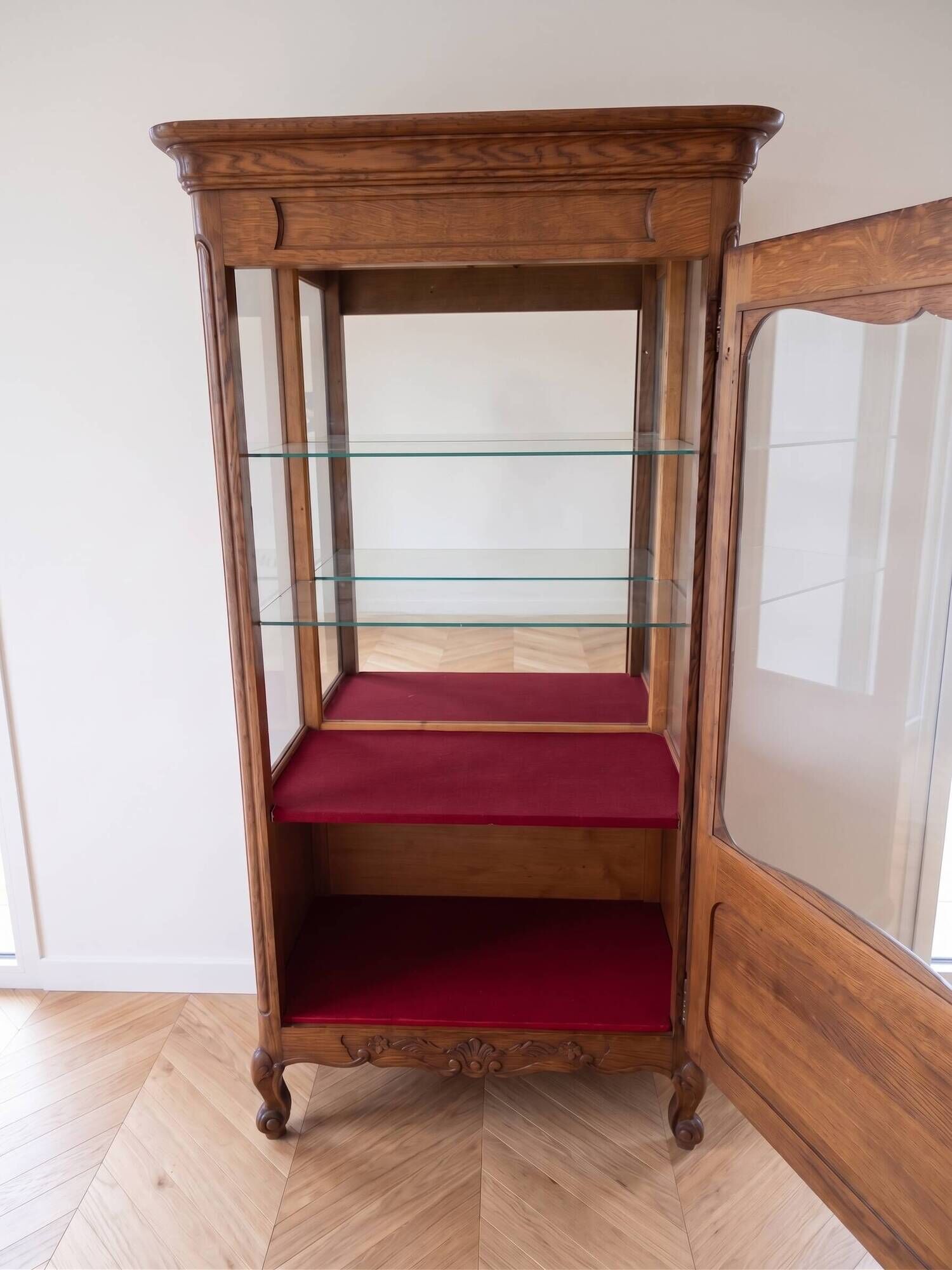 Vintage wooden display cabinet with glass shelves.