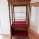 Vintage wooden display cabinet with glass shelves.