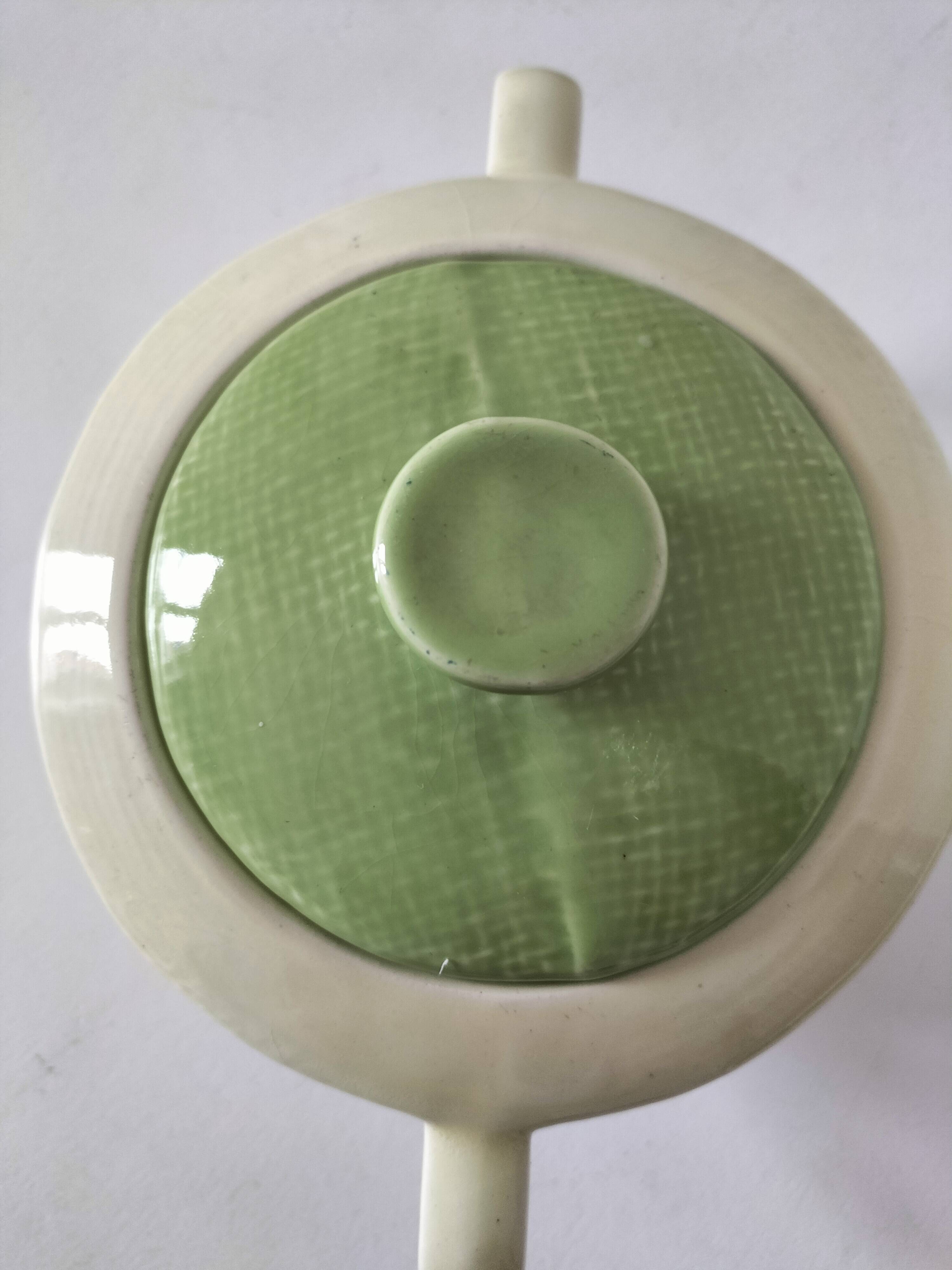 Two sugar bowls and a textured plate in turquoise and green Salins earthenware.