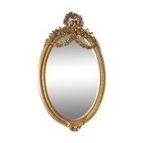 Golden oval mirror with a bow and a flower crown