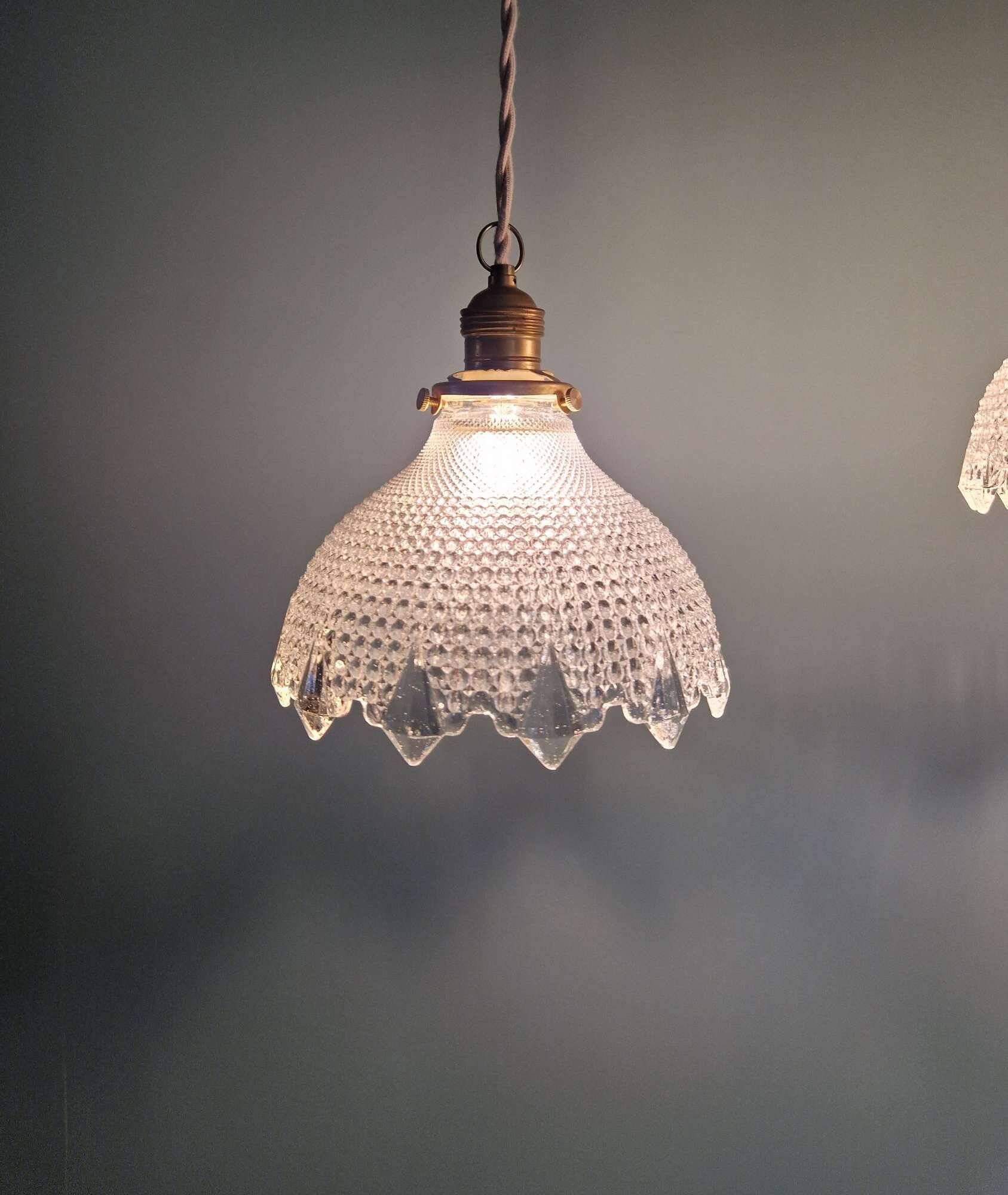 Trio of Art Deco scalloped clear glass pendant lights, 1920-30