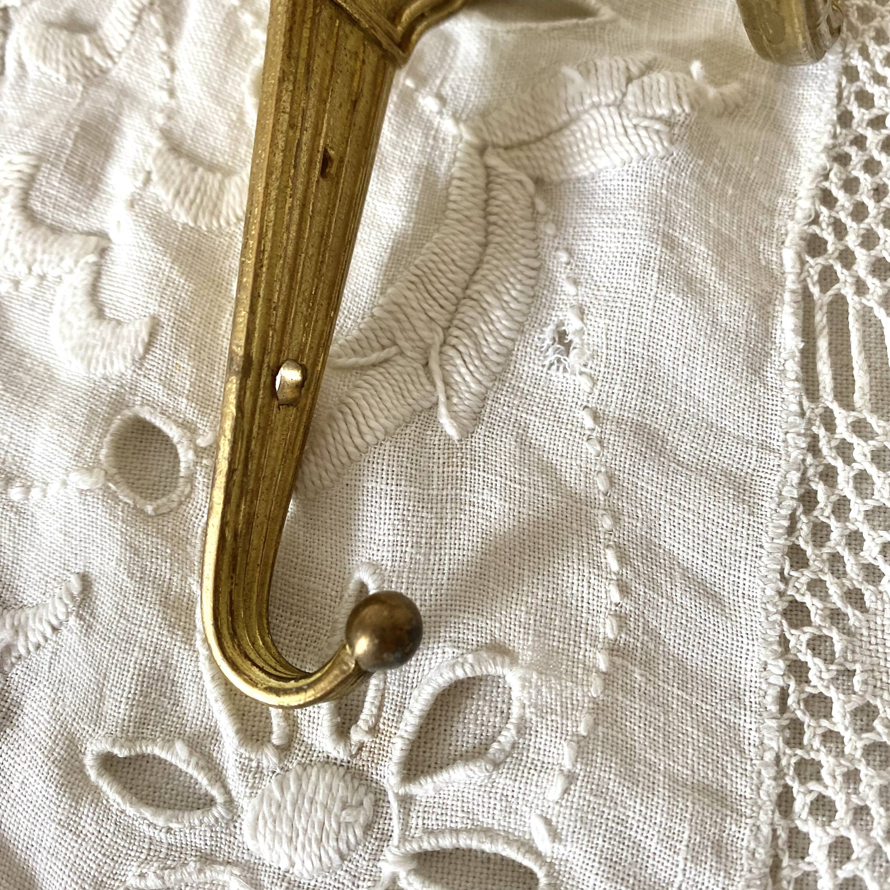 Golden brass coat hook