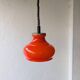 Suspension drop-and-rise in orange opaline from the 1970s.