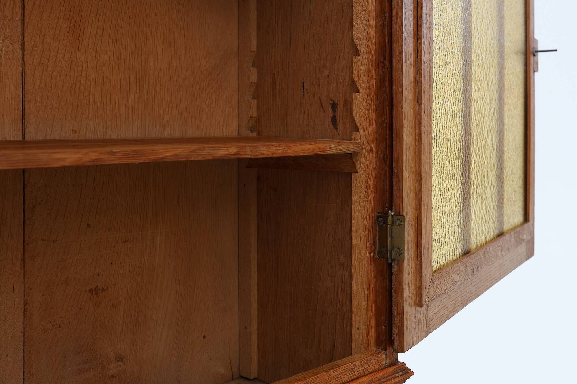 Art Deco oak wall cabinet with amber glazed door, Belgium ca. 1925