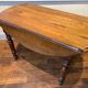 Table with oval shutter in walnut foot turned