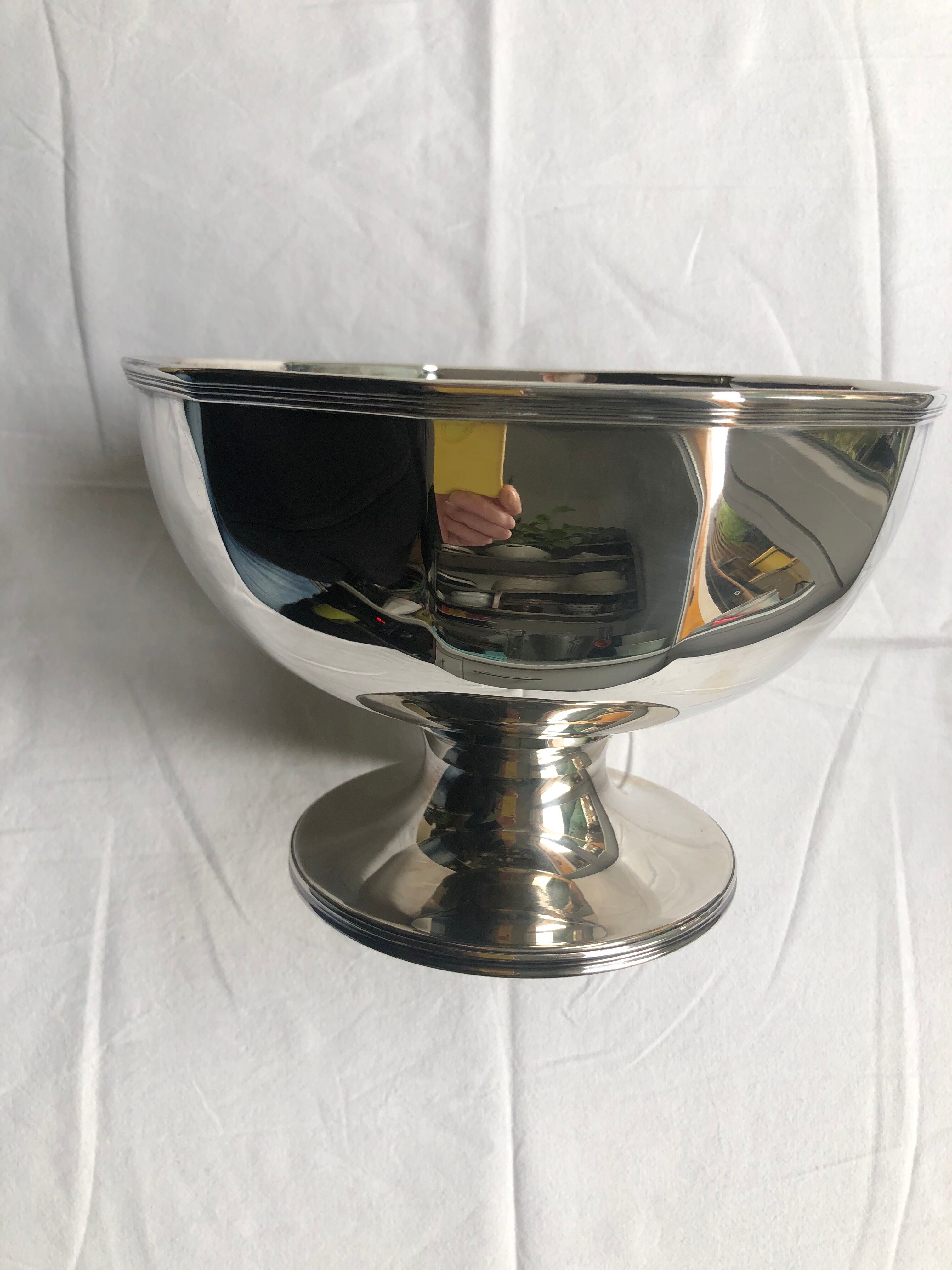 Silver metal cut with panels cut on pedestal, Christian Dior