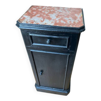 Chest of drawers with a red marble top.