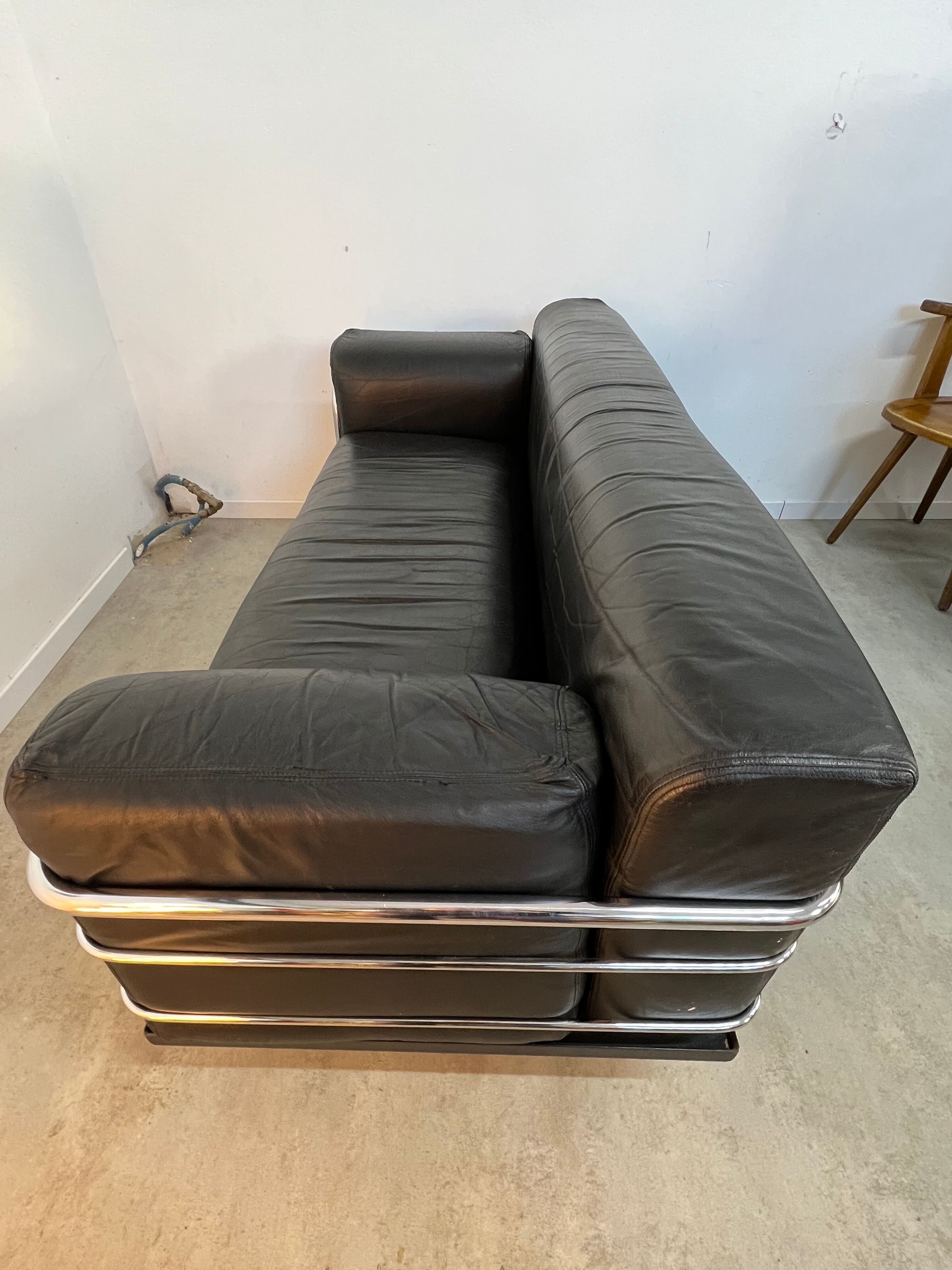 Old vintage leather and tubular metal sofa, design 70s