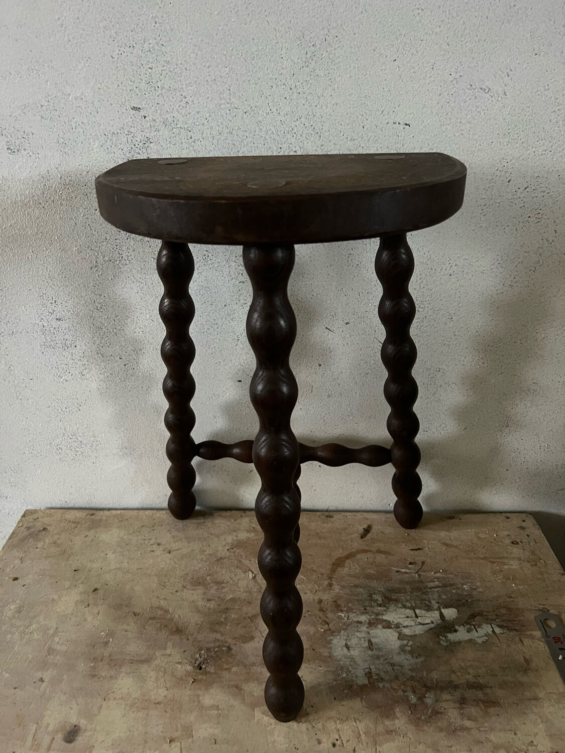 Wooden tripod farm stool