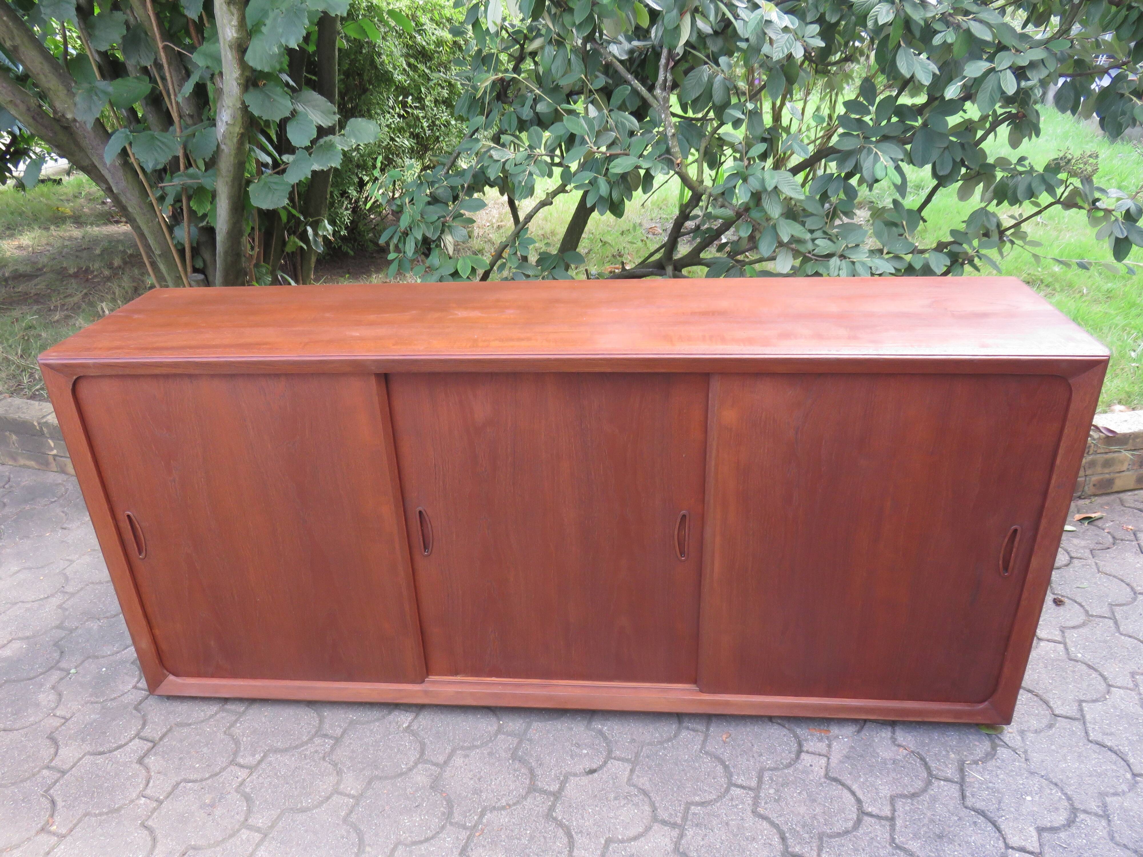 Low sideboard with 3 sliding doors in teak. Denmark 1960