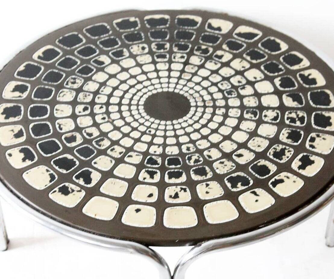 Black and white round coffee table with a mandala top and chrome metal base.