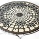 Black and white round coffee table with a mandala top and chrome metal base.