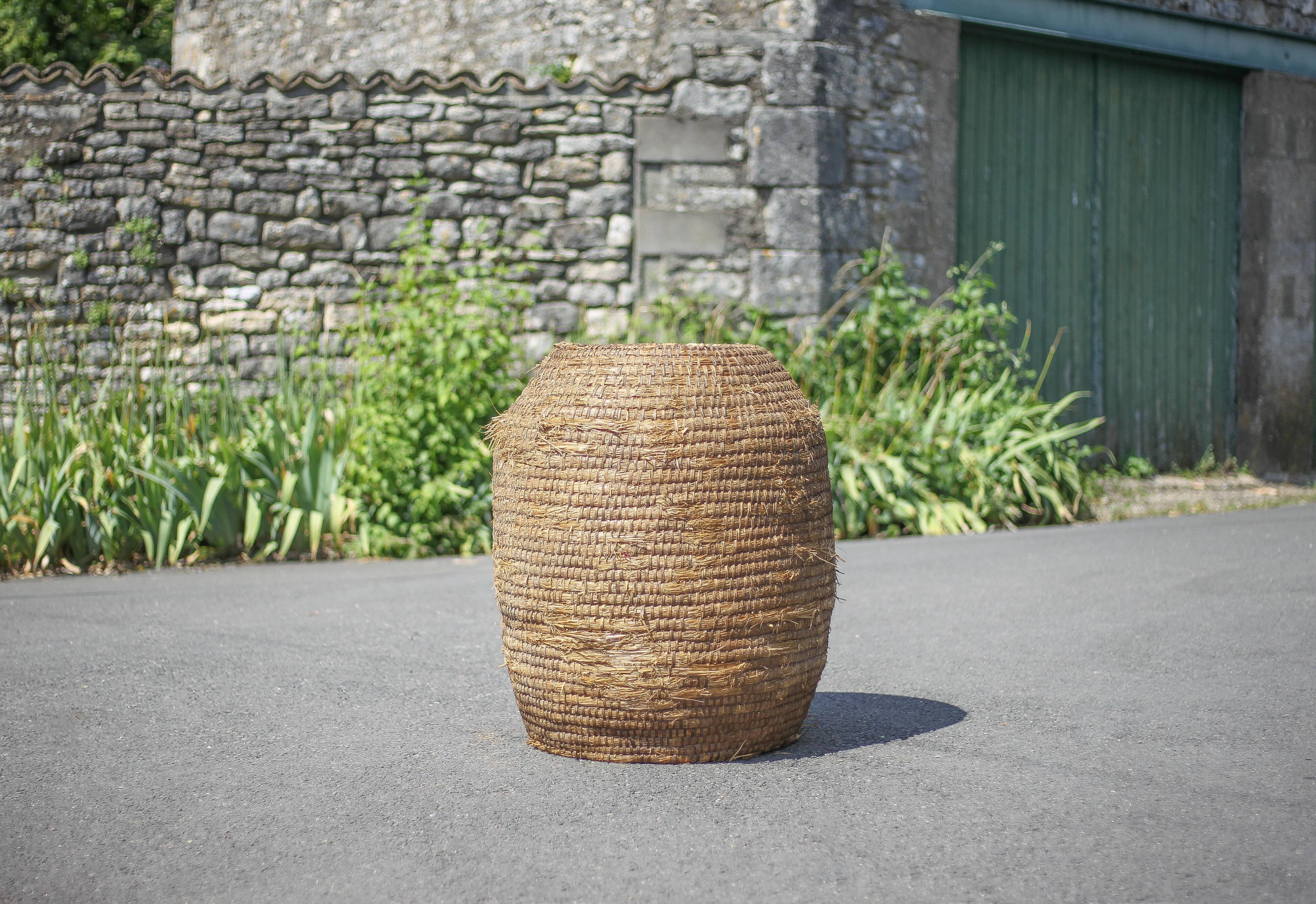Very large old basket, burgundy straw and bramble, woven basket