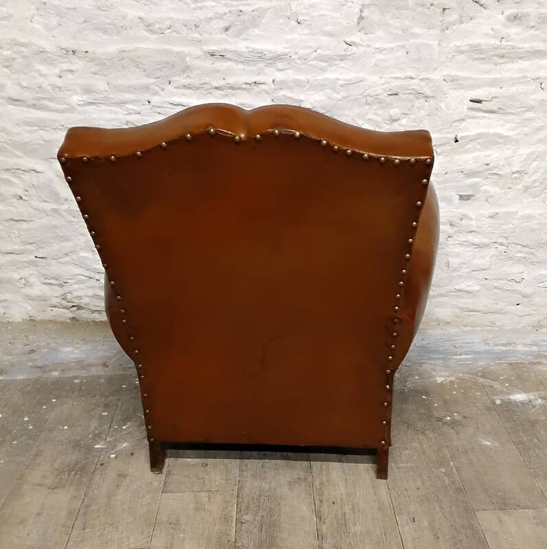 Antique club chair with mustache back