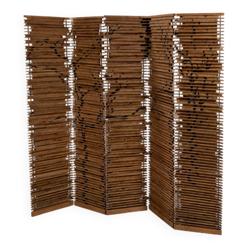 Wooden screen with slats, black plant decoration.