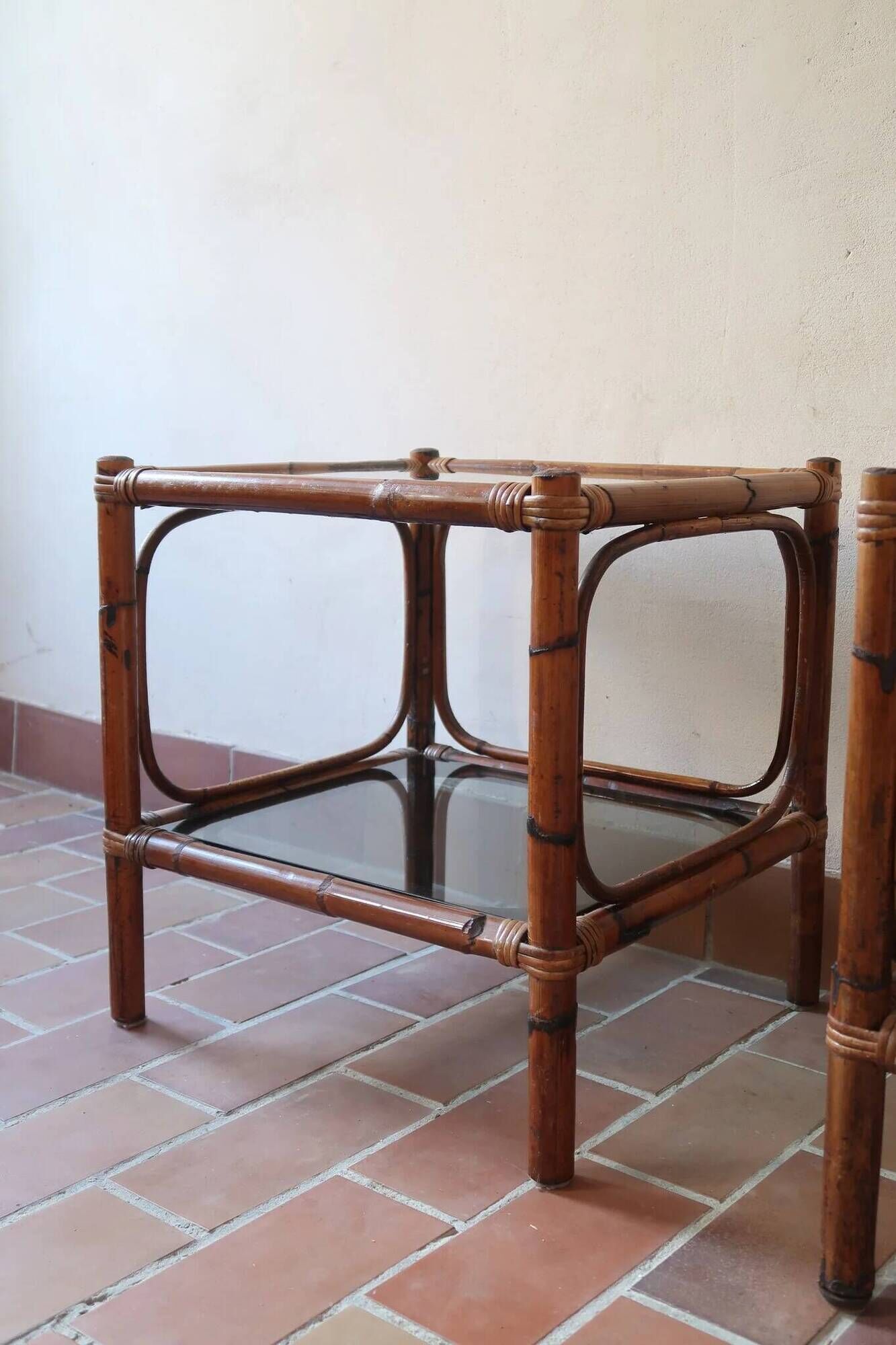 Pair of bamboo and rattan bedside tables, smoked glass tops.