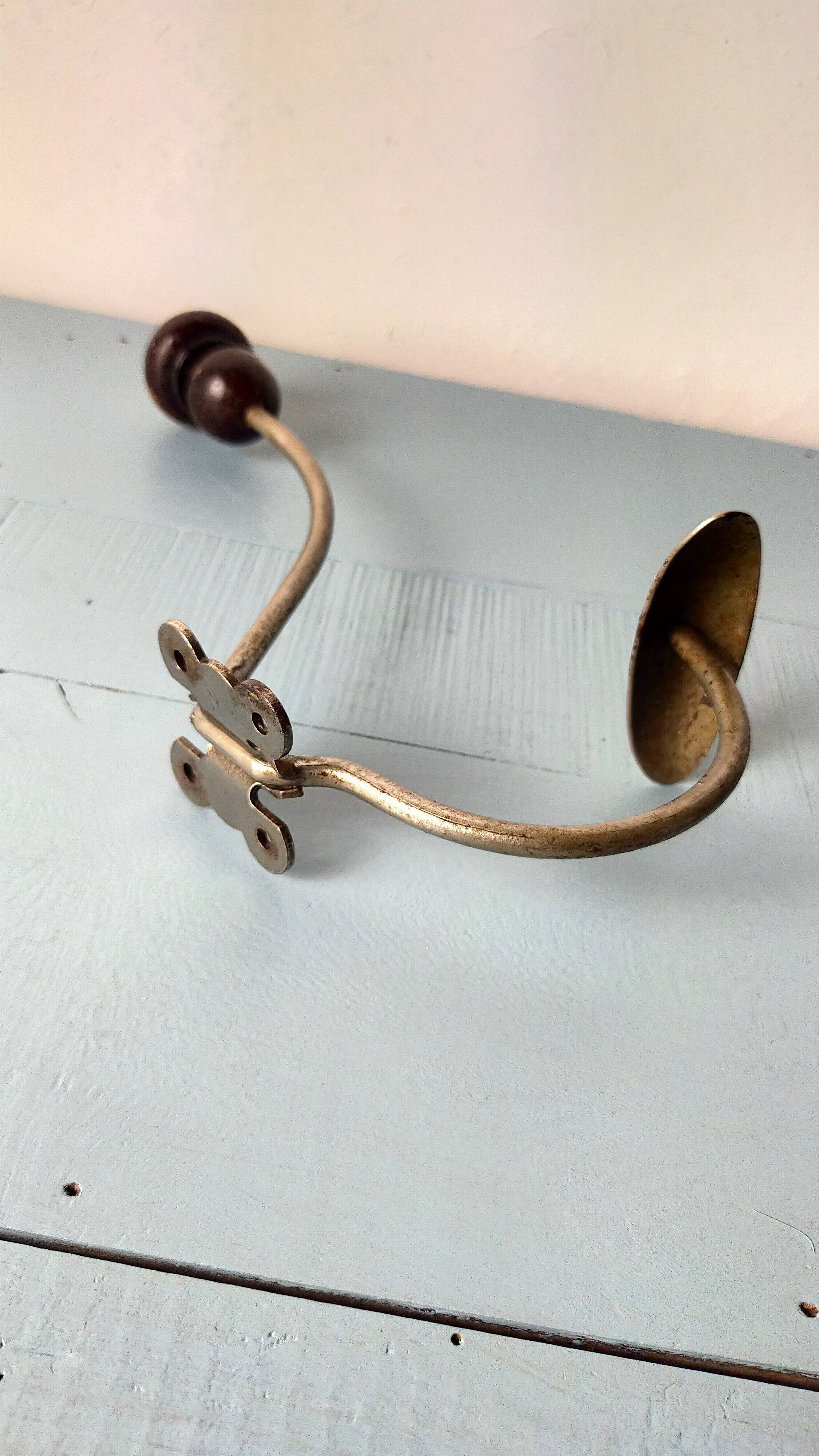 Antique coat rack with red wooden ball