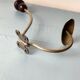 Antique coat rack with red wooden ball