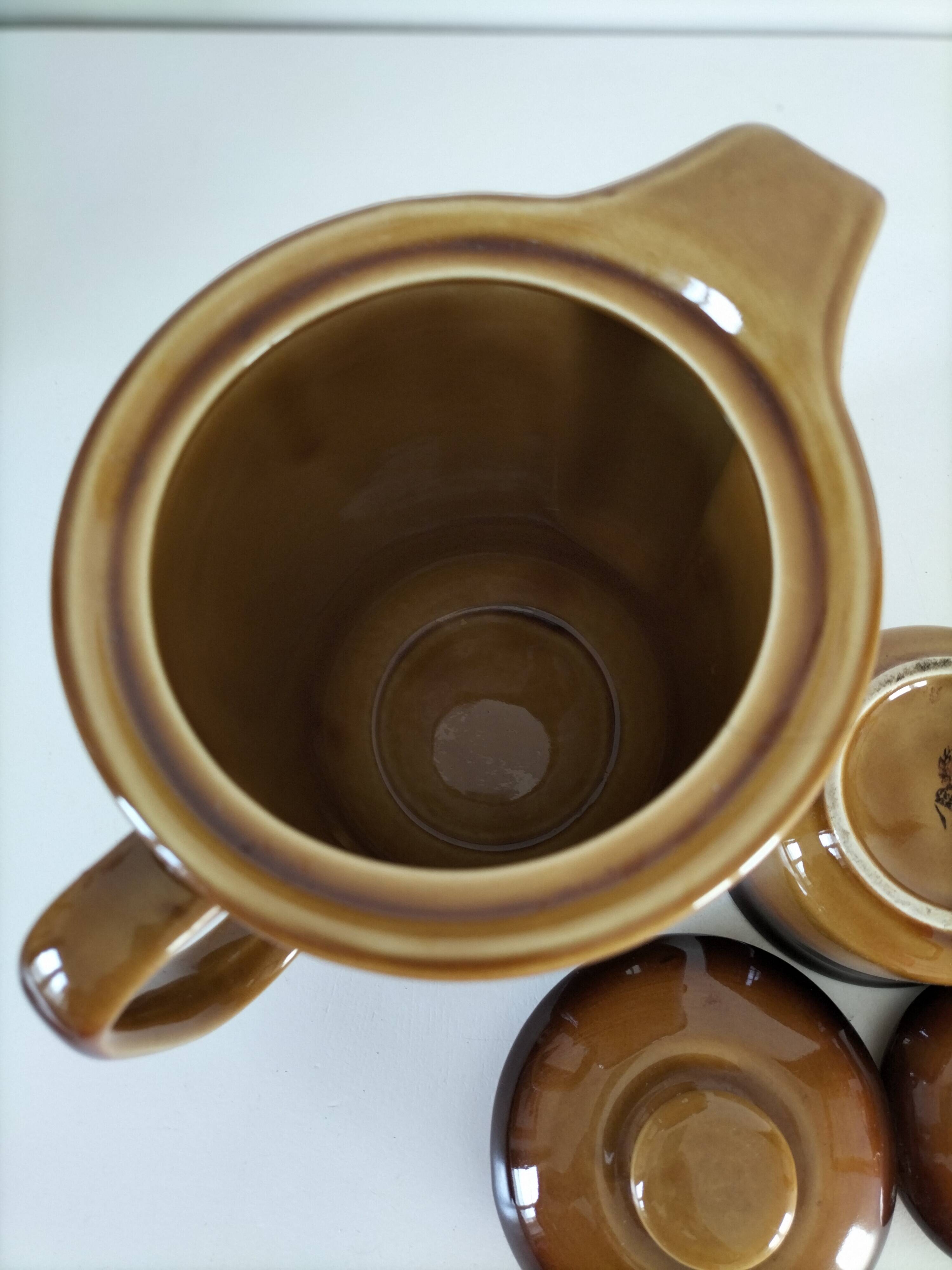 Coffee pot and sugar bowl in glazed stoneware, deep brown glazes.