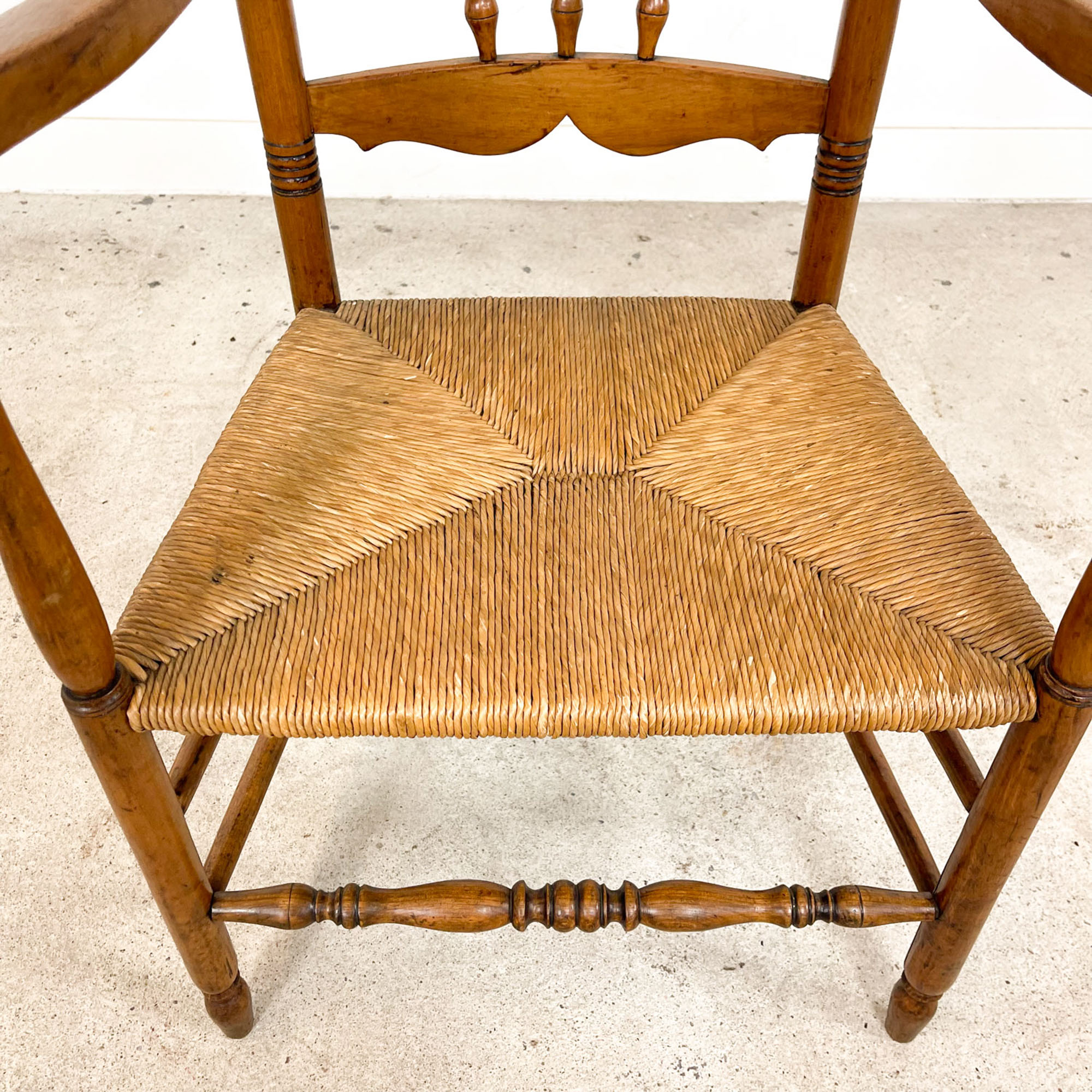 Antique oak and elm wooden armchair with cane seat