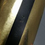 Older wall lamp in brass with hard pressed glass shade.