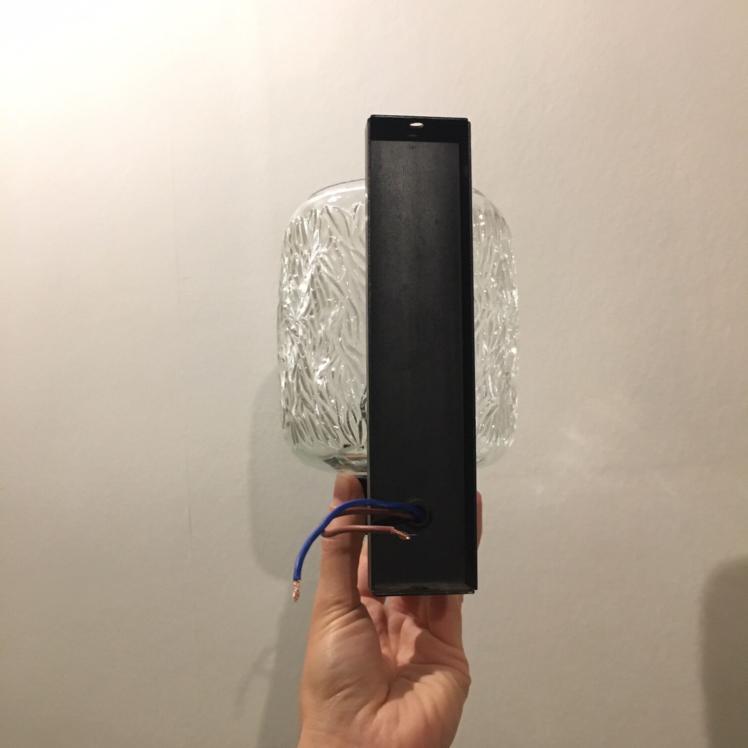 Black metal and molded glass wall sconce