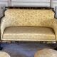 A set of two armchairs, a sofa and two poufs in lacquered wood with gilded chinoiserie decoration.