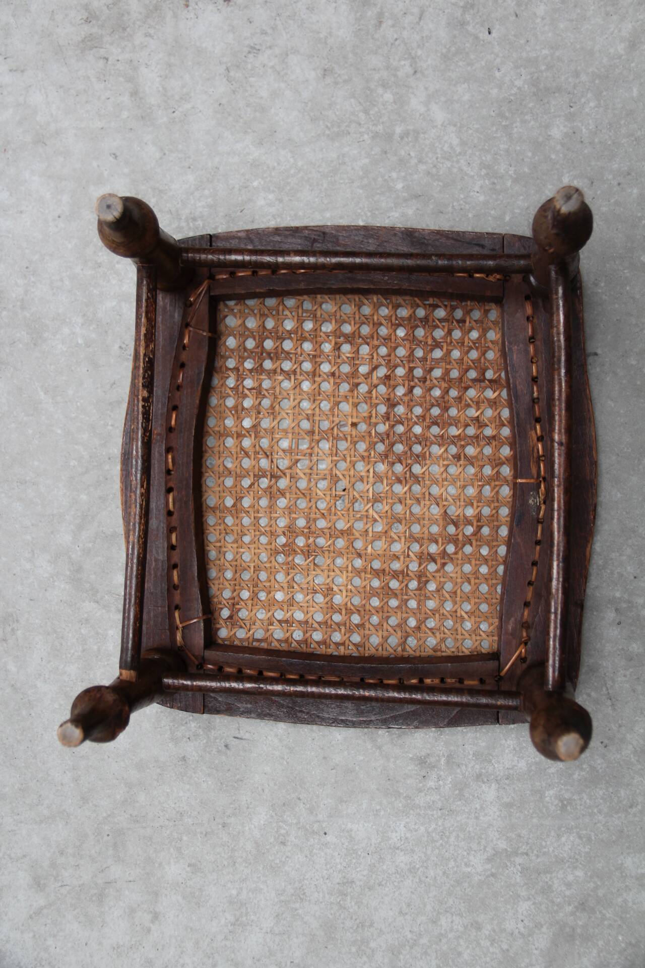 Antique caned wood footrest