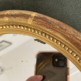 Oval mirror in gilded wood.