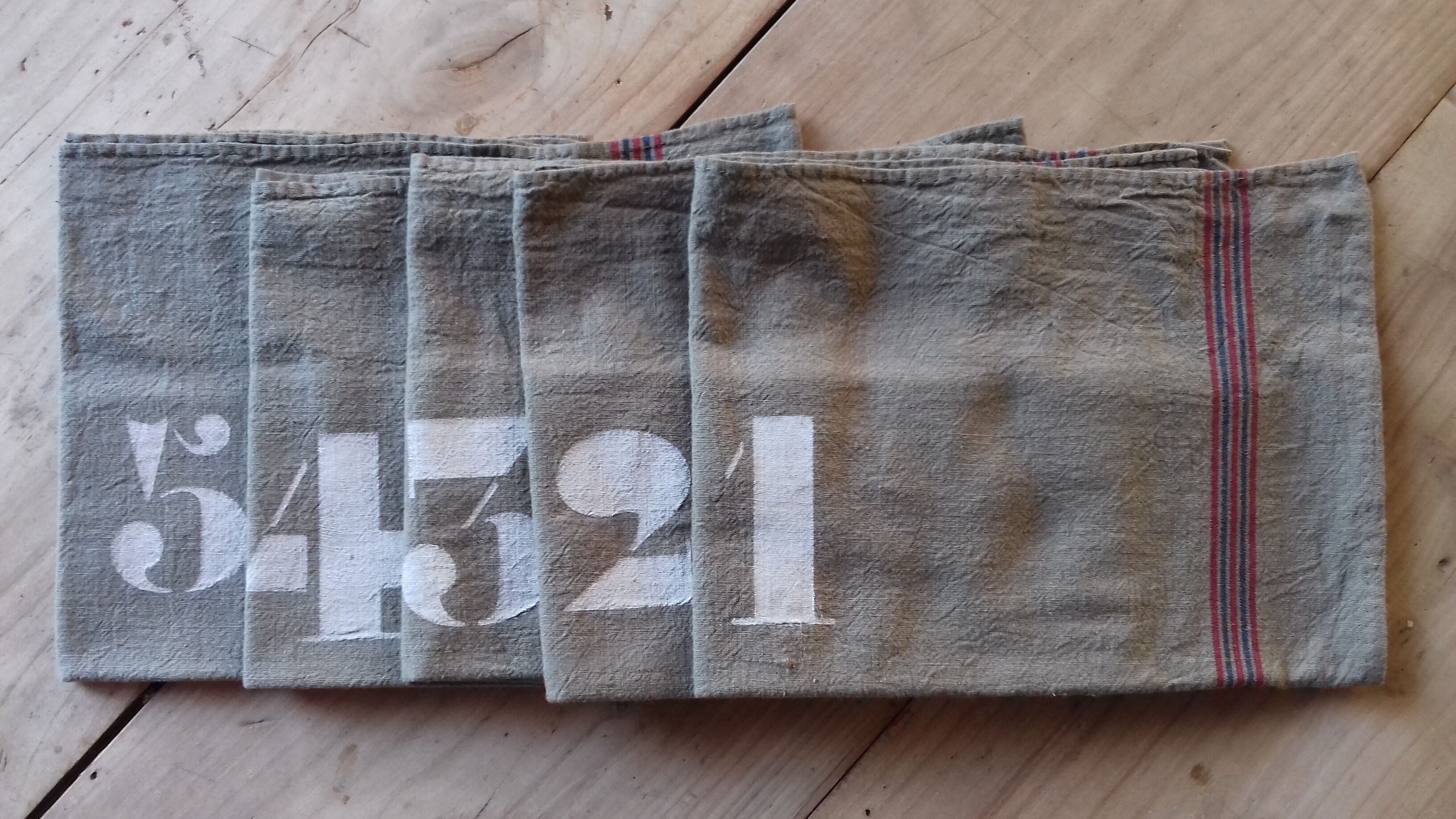 10 numbered khaki tea towels