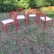 Stackable chairs, Italy, 1980s, red metal, white vinyl