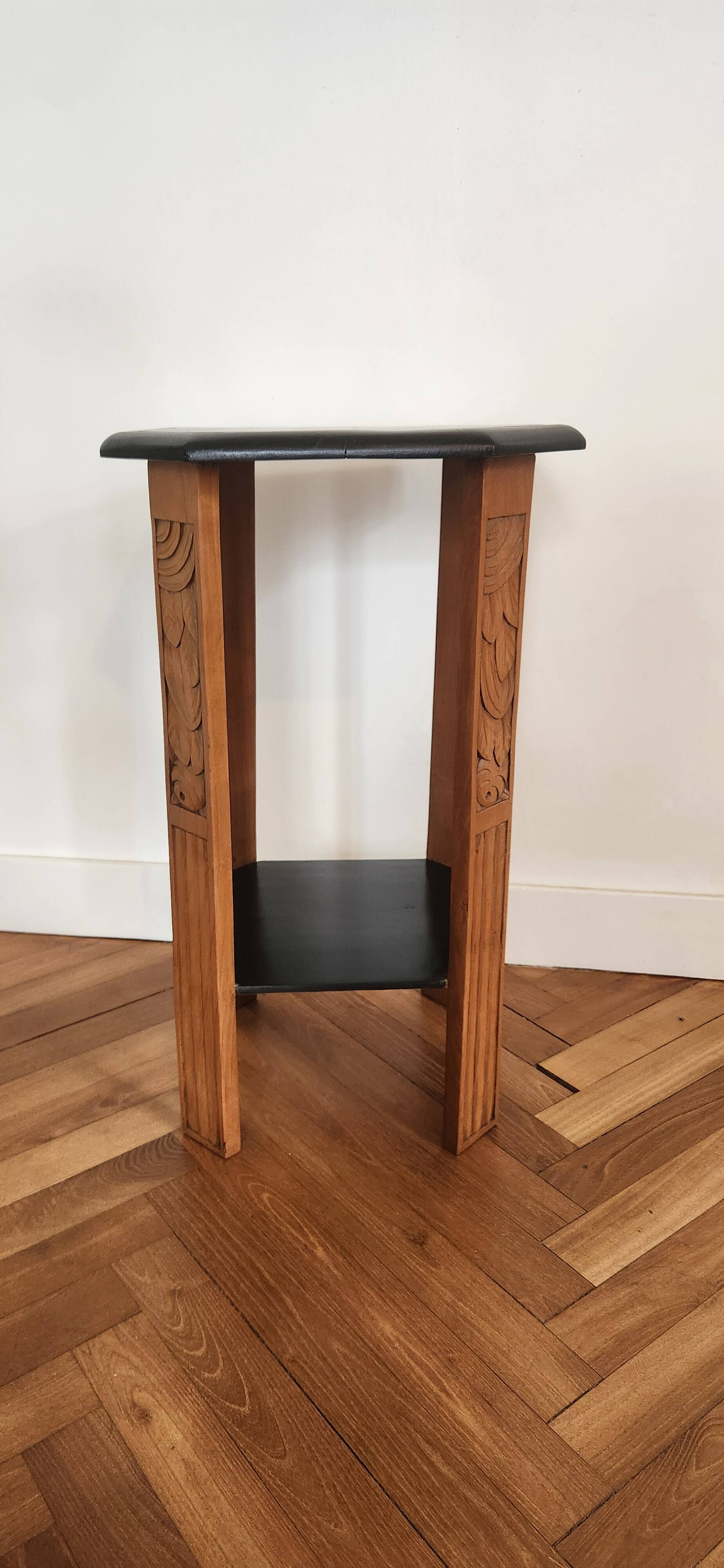 Art Deco console with sculpted black lacquered legs.